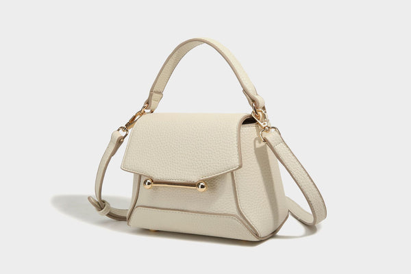Small structured pebbled flap mini satchel with gold-tone bar hardware, short top handle, and detachable crossbody strap