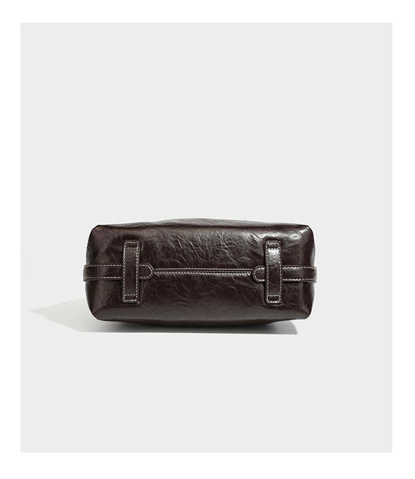 Slouchy hobo shoulder bag in glossy crinkled leather-look finish with zip-top closure and silver-tone ring hardware, detail