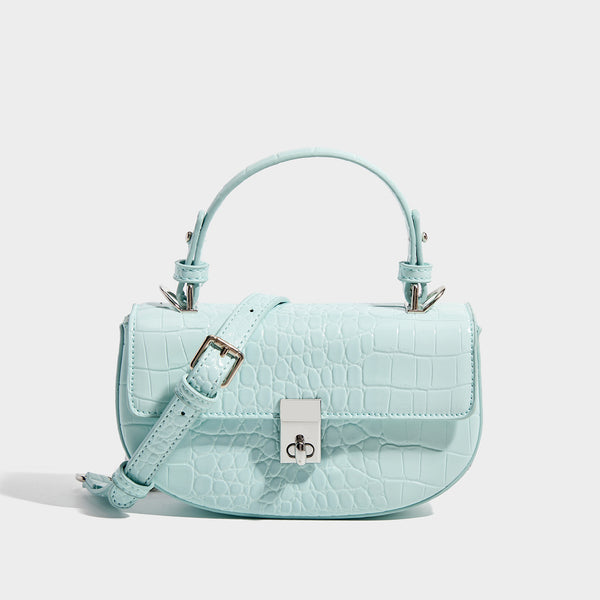 Glossy croc-embossed mini saddle bag with silver-tone turn-lock clasp and short top handle, front view