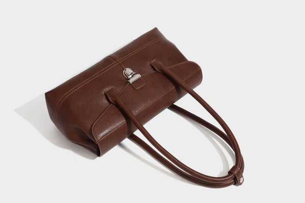 Structured rectangular satchel bag with dual rounded top handles and central metal turn-lock flap closure, detail view 22