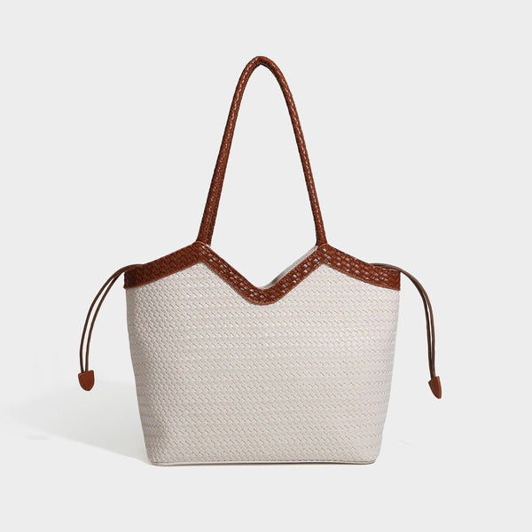 Woven tote bag with braided shoulder straps, drawstring closure, and dangling metal-and-bead charm, detail view 4