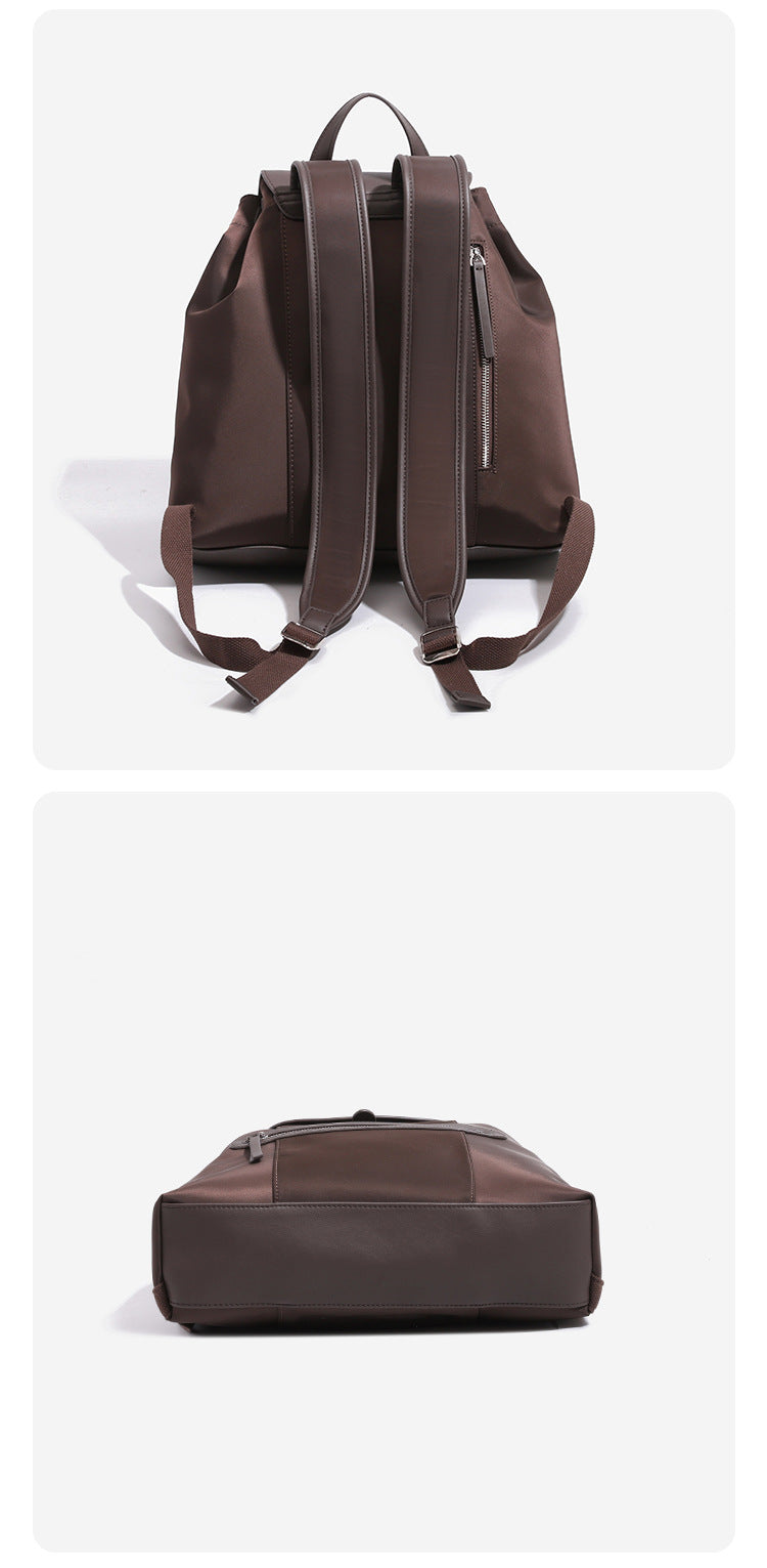 Large flap-top nylon backpack with leather-look trim, snap closure, front zip pocket, and padded shoulder straps, detail view