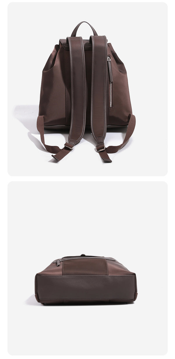 Large flap-top nylon backpack with leather-look trim, snap closure, front zip pocket, and padded shoulder straps, detail view