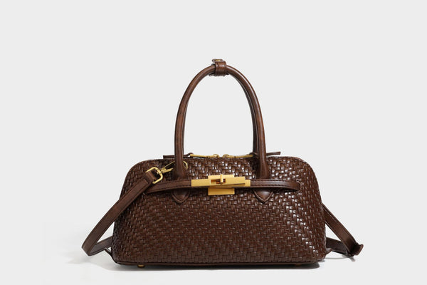 Structured woven-embossed leather-look satchel with dual rolled top handles, gold-tone turn-lock closure, and detachable