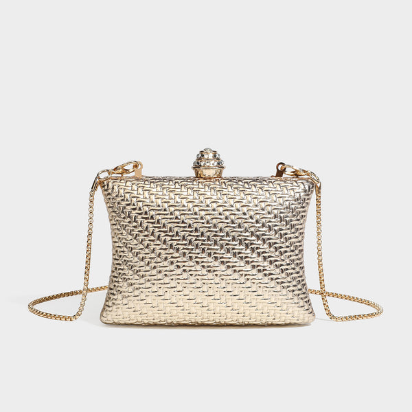Small structured rectangular metallic woven-texture clutch bag with jeweled knob clasp and gold-tone chain strap, detail view
