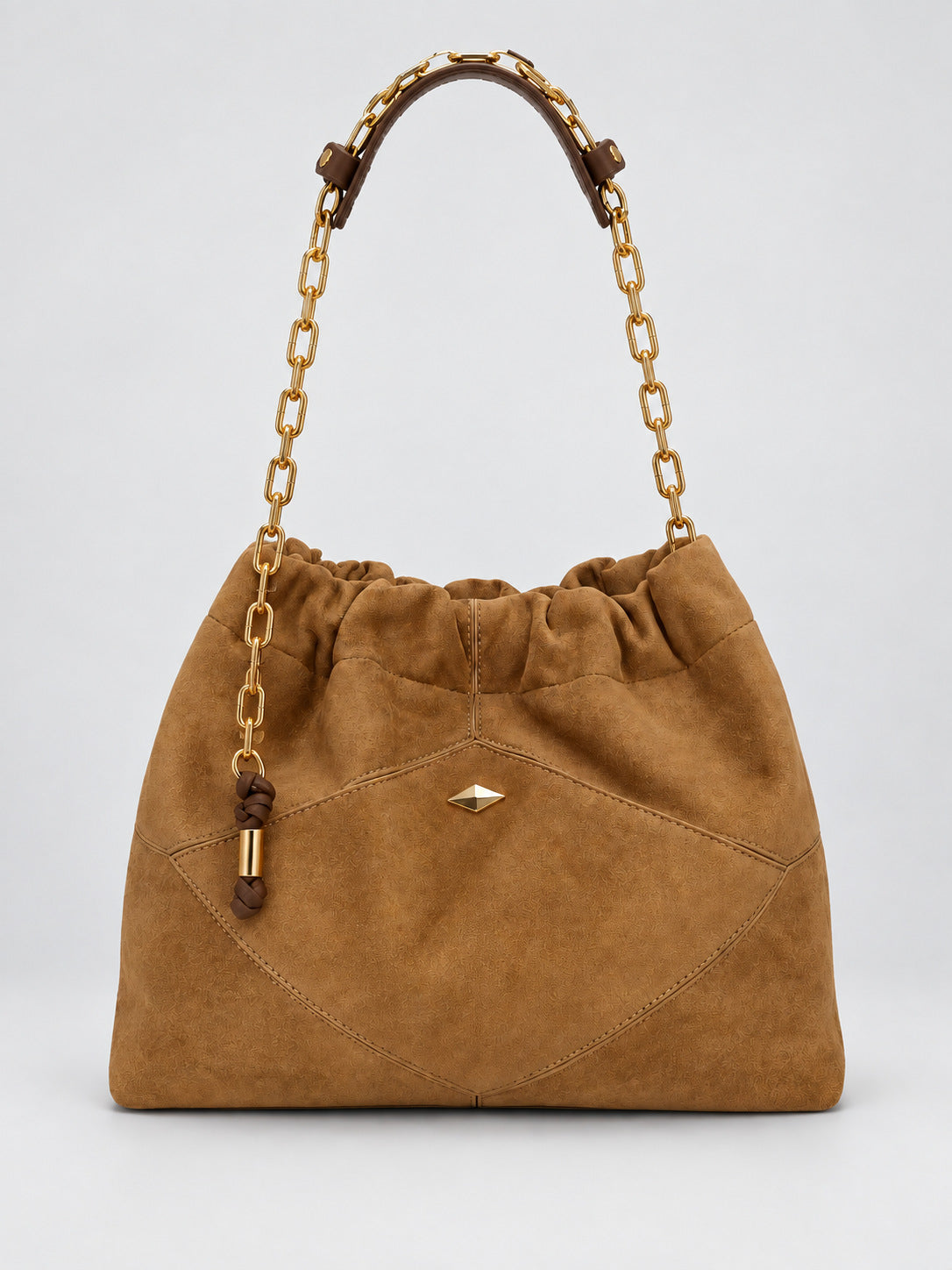 Slouchy suede-look shoulder bag with gathered top, angular stitched paneling, and chunky gold-tone chain strap, detail view