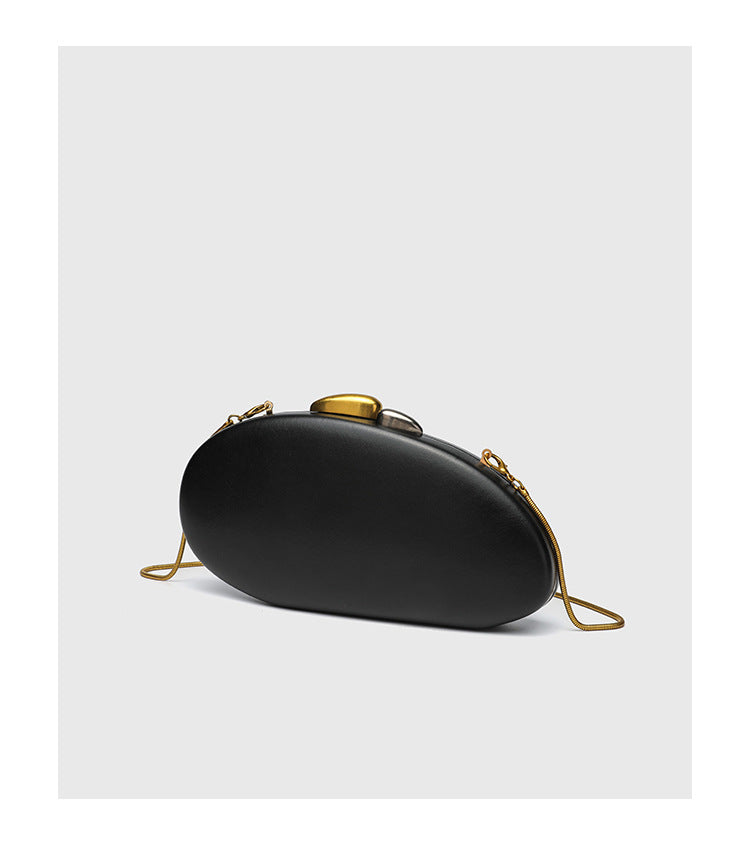 Oval hard-shell crossbody clutch bag with smooth matte leather-look finish and gold-tone snake chain strap, detail view 13