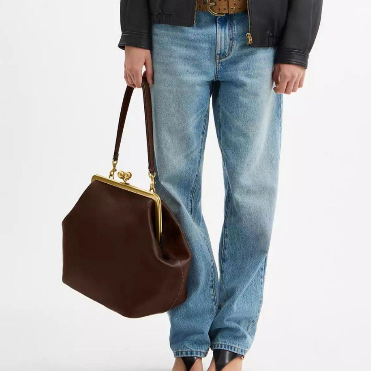 Oversized kiss-lock frame handbag with gold-tone metal clasp and smooth leather-look finish, detail view 2