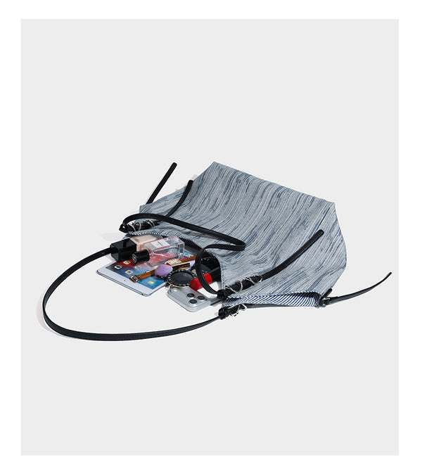 Large slouchy woven-texture shoulder tote bag with slim leather-look straps, side cinch ties, and silver-tone hardware
