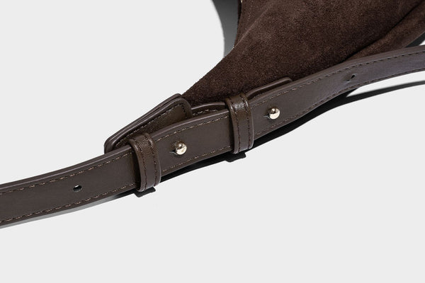 Slouchy crescent hobo shoulder bag in dark chocolate matte suede-look finish with adjustable strap and twin-pull top zip