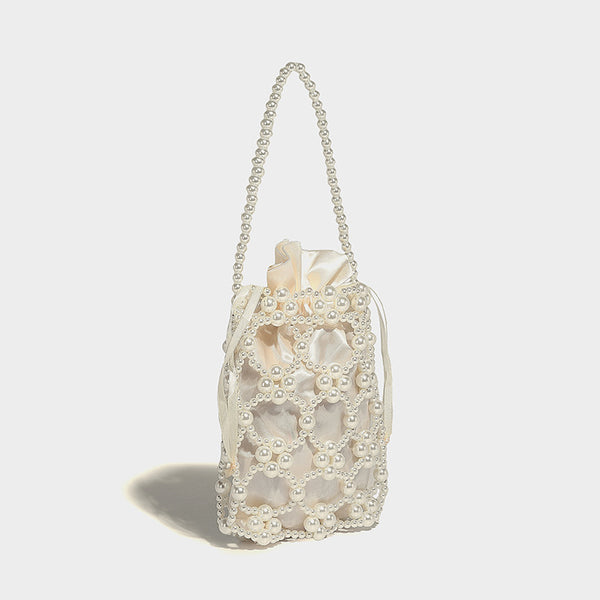 Small pearl-beaded lattice drawstring bucket bag with beaded shoulder strap and ribbon closure, detail view 17