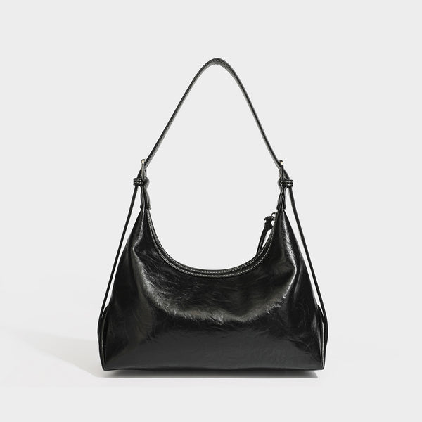 Slouchy hobo shoulder bag in glossy crinkled leather-look finish with zip-top closure and silver-tone ring hardware, detail