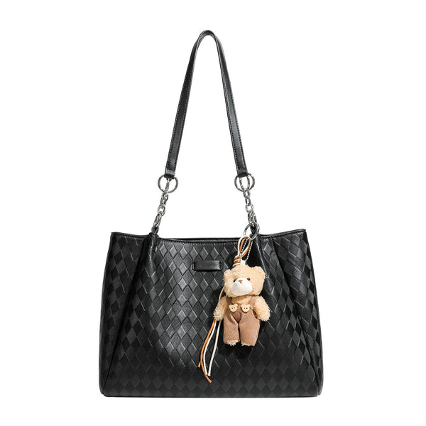Black diamond-quilted leather-look tote bag with silver chain-ring shoulder straps and plush bear charm pendant, detail view