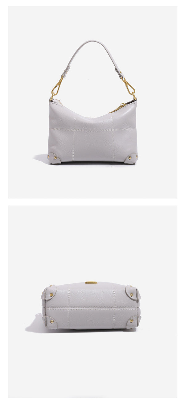 Small soft-structured shoulder bag with curved zip closure, stitched panel detailing, and gold-tone hardware, detail view 14