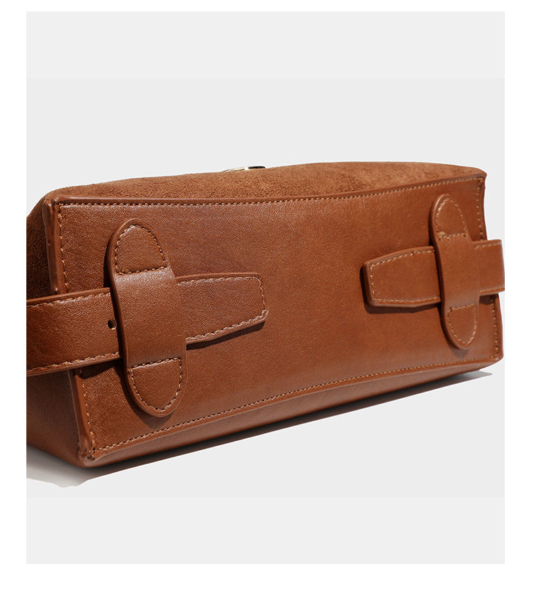 Slouchy suede-finish brown shoulder bag with long single strap and small gold-tone logo emblem on front, detail view 21