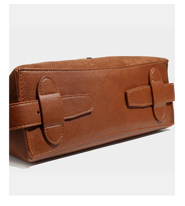 Slouchy suede-finish brown shoulder bag with long single strap and small gold-tone logo emblem on front, detail view 21