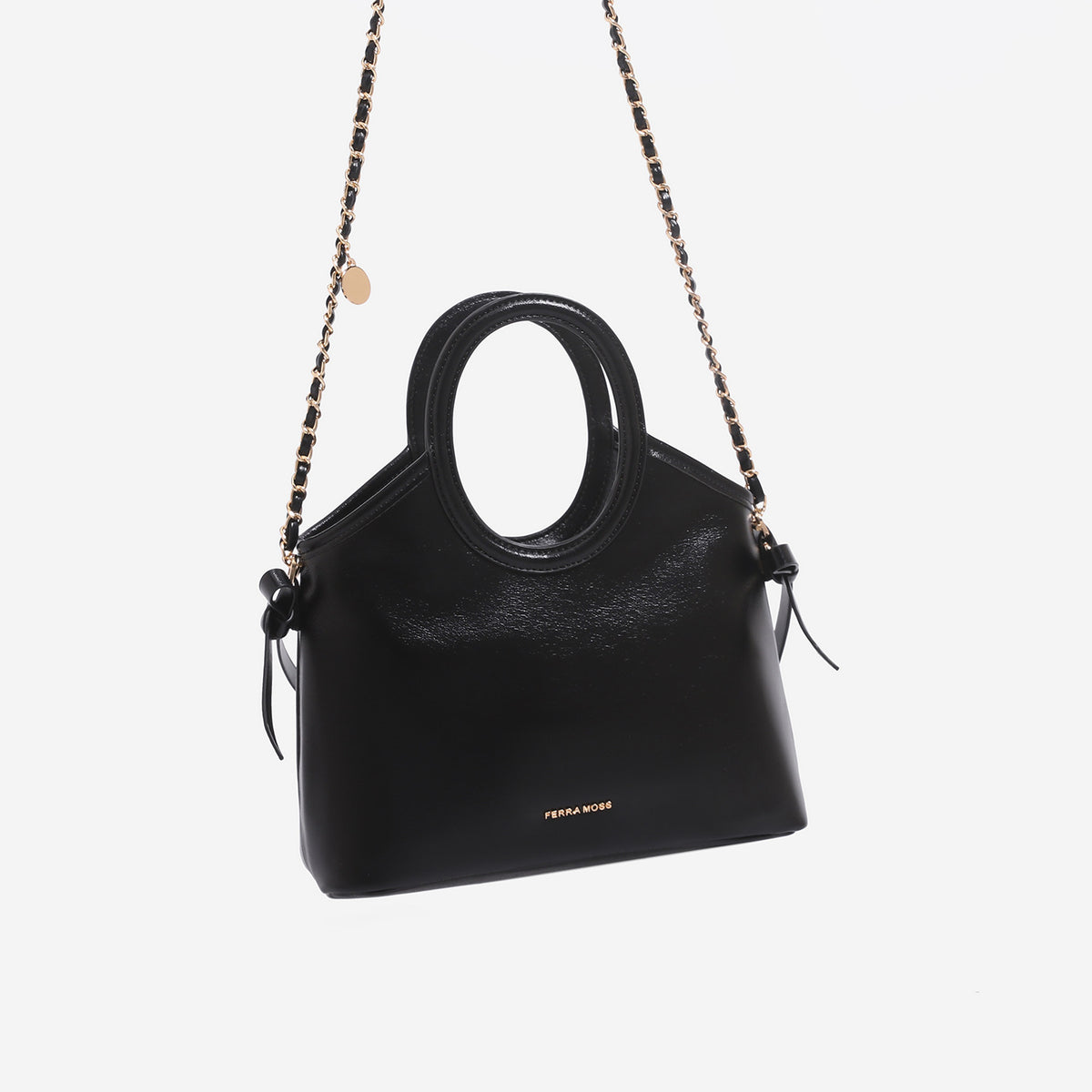 Structured trapezoid tote bag with oval top handle, glossy leather-look finish, side tie details, and gold-tone hardware