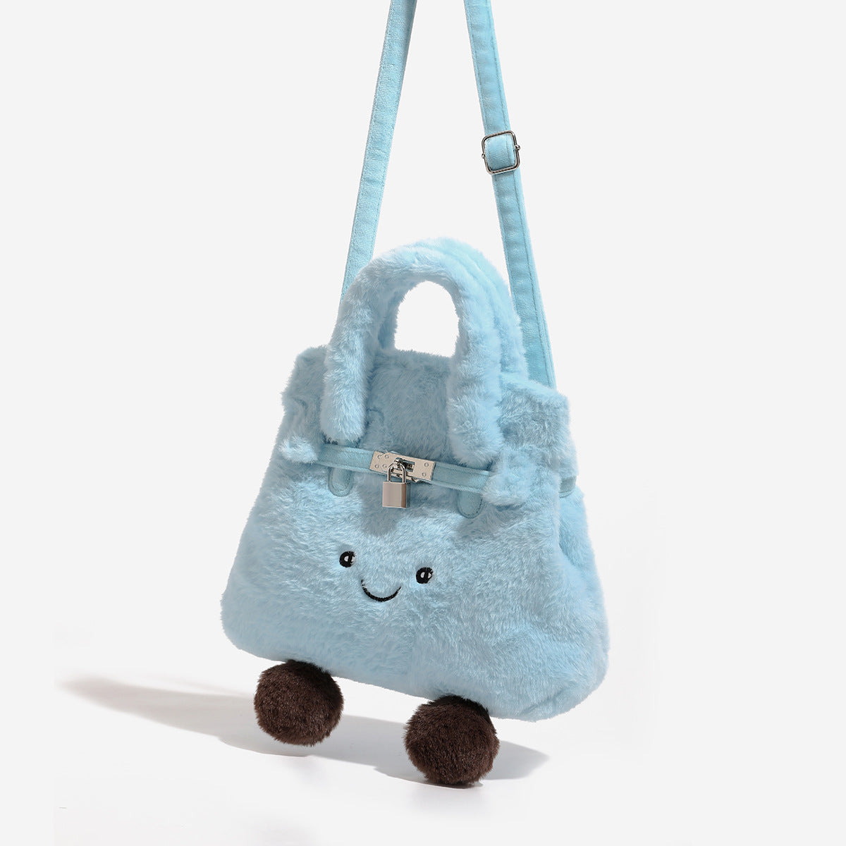 Ice-blue plush faux-fur Kelly-style convertible bag with embroidered smiling face, dark pom-pom feet, silver-tone clasp