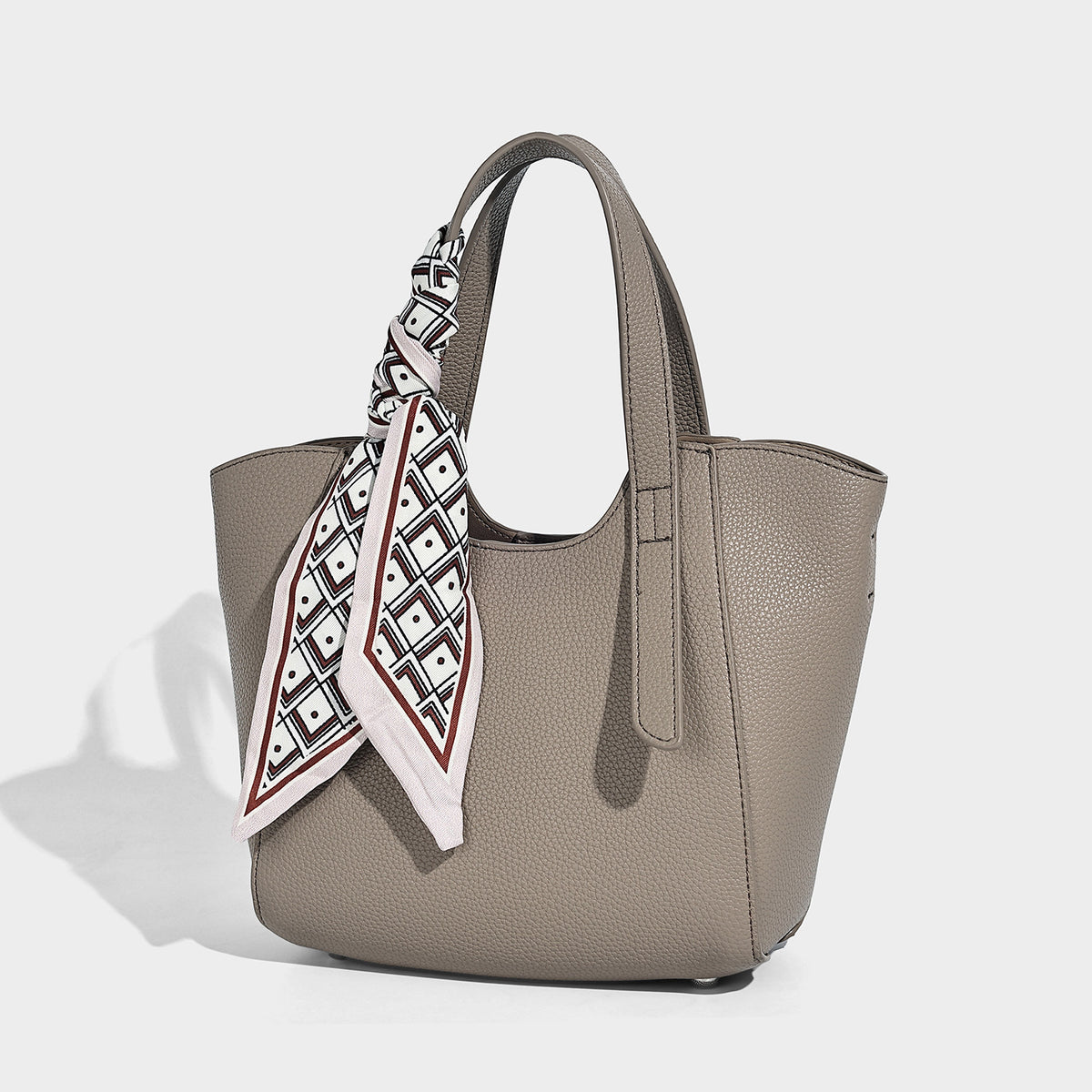 Structured pebbled leather-look tote bag with detachable scarf tie, dual top handles, and adjustable crossbody strap, front