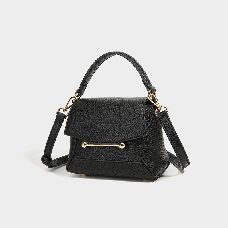 Small structured pebbled flap mini satchel with gold-tone bar hardware, short top handle, and detachable crossbody strap