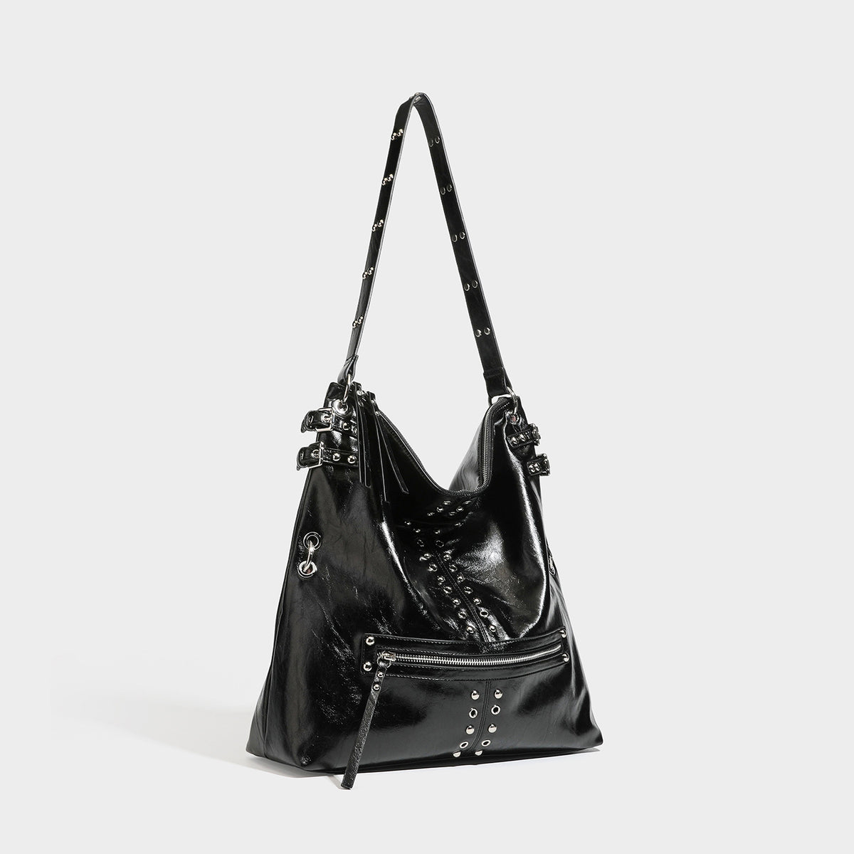 Black glossy leather-look slouchy shoulder bag with silver stud and eyelet hardware, top zip closure, front zip pocket, and