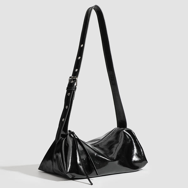Black glossy leather-look slouchy shoulder bag with gathered top, zip tassel closure, and long adjustable silver-buckle