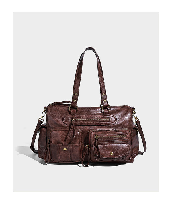 Distressed leather-look vintage satchel shoulder bag with multiple front zip pockets, dual top handles, and brass-tone