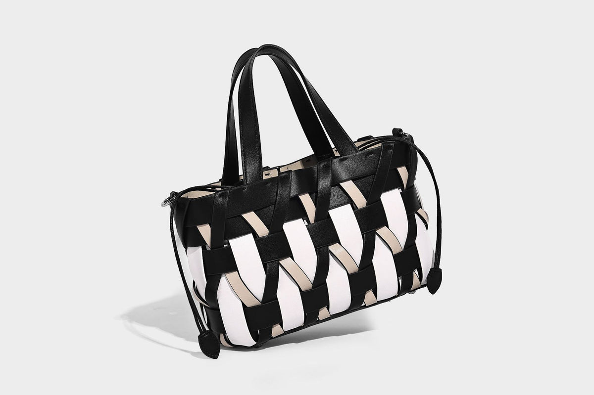 Small structured woven lattice tote bag with dual top handles and detachable shoulder strap in brown and cream leather-look