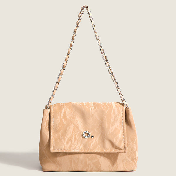 Crinkle-finish leather-look shoulder bag with woven tan-and-metal chain strap and front flap turn-lock closure, front view