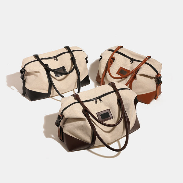 Large cream canvas tote bag with dark leather-look trim, dual top handles, and detachable shoulder strap, detail view 3