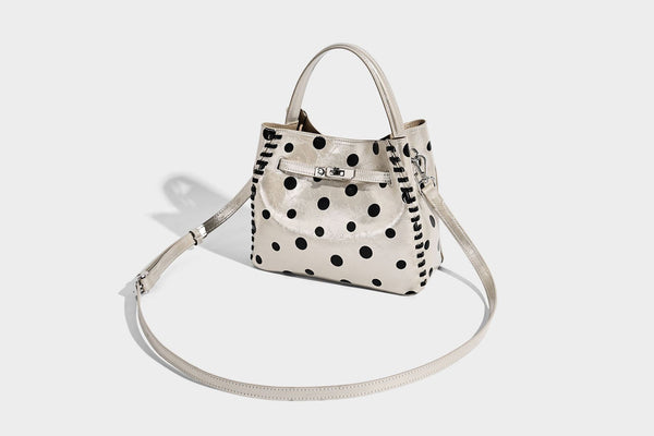 Glänzende, geknautschte Beuteltasche mit Polka-Dots, silberfarbenen Schnallenbeschlägen, kontrastierendem seitlichem Schnürbesatz, Tragegriff und abnehmbarem
