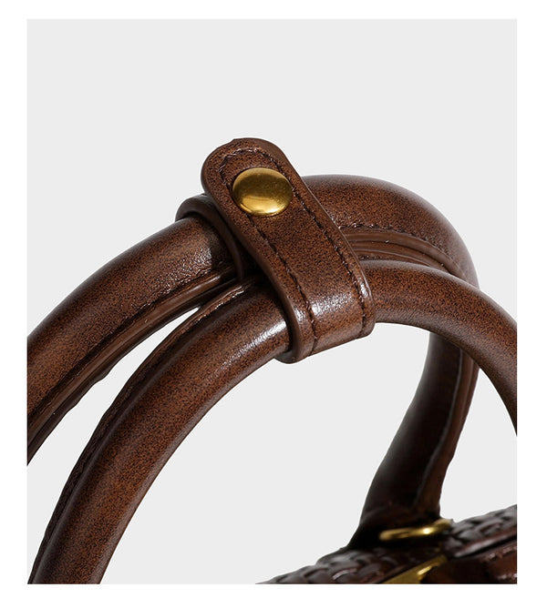 Structured woven-embossed leather-look satchel with dual rolled top handles, gold-tone turn-lock closure, and detachable