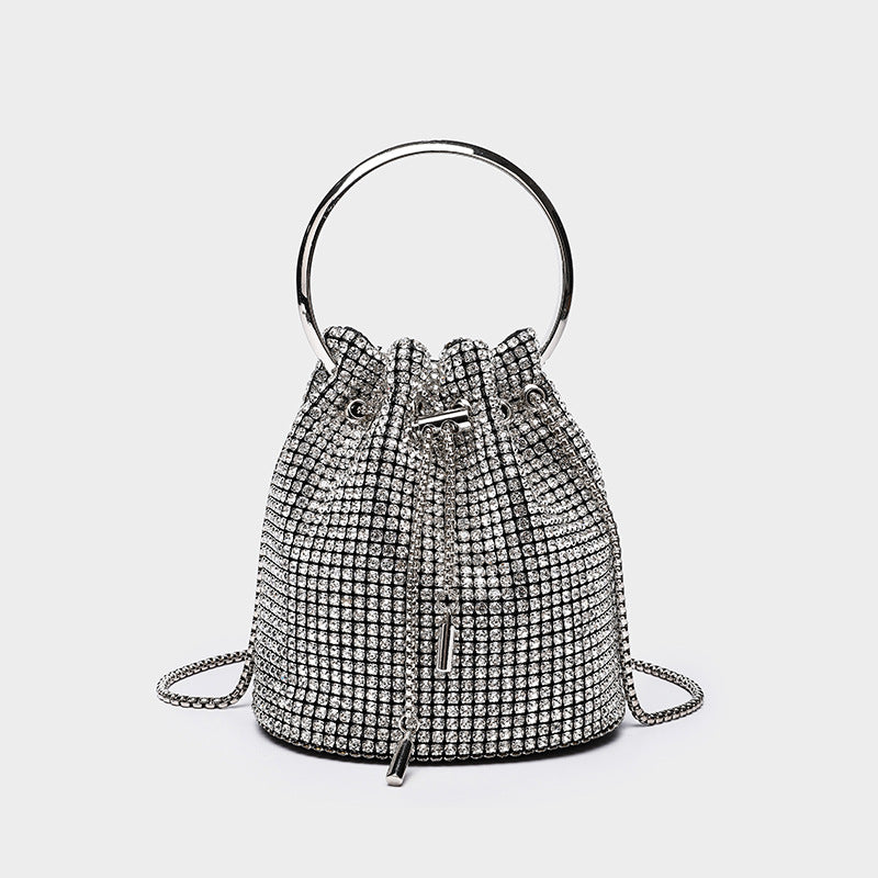 Small crystal rhinestone bucket bag with silver-tone ring handle and chain shoulder strap, drawstring closure, detail view 2