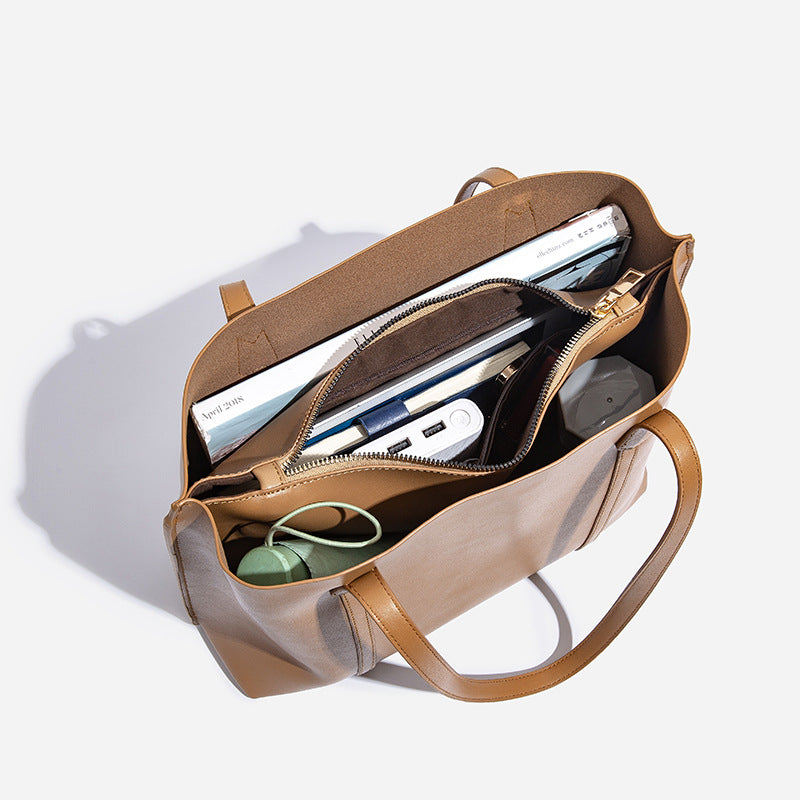 Large structured leather-look tote bag with belt-strap detail and gold-tone hardware, detail view 4