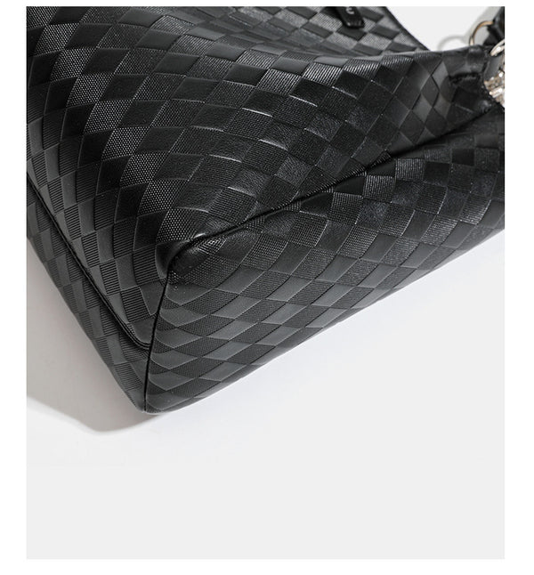 Black diamond-quilted leather-look tote bag with silver chain-ring shoulder straps and plush bear charm pendant, detail view