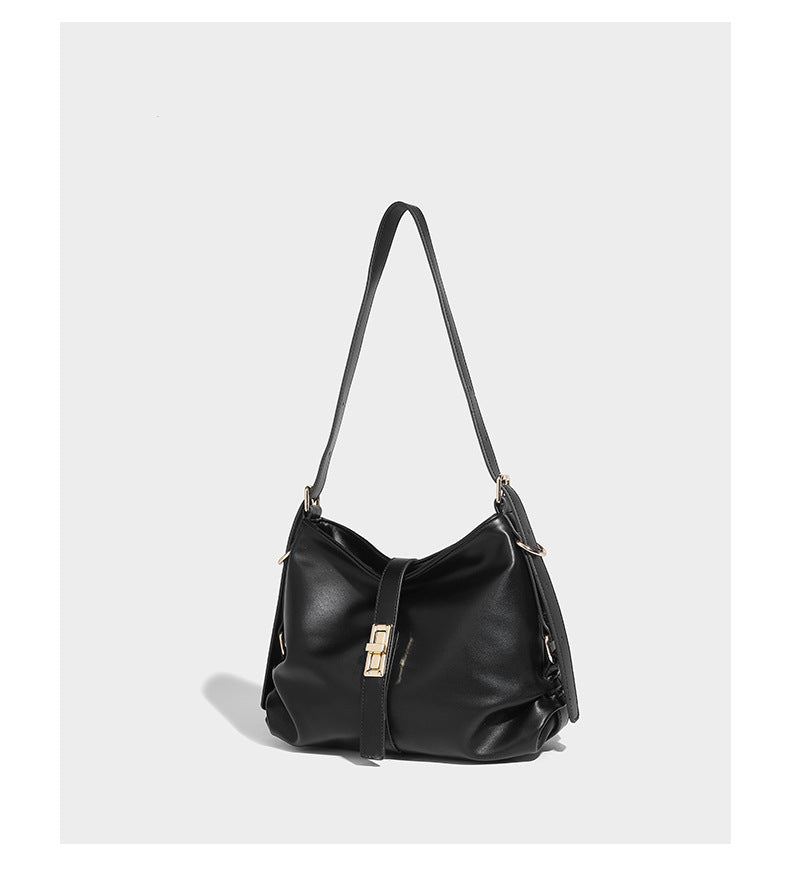 Soft slouchy hobo shoulder bag with smooth leather-look finish, gold-tone buckle and tab hardware, and long adjustable strap