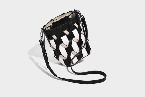 Small woven lattice bucket bag in tan and cream leather-look strips with drawstring top and detachable crossbody strap