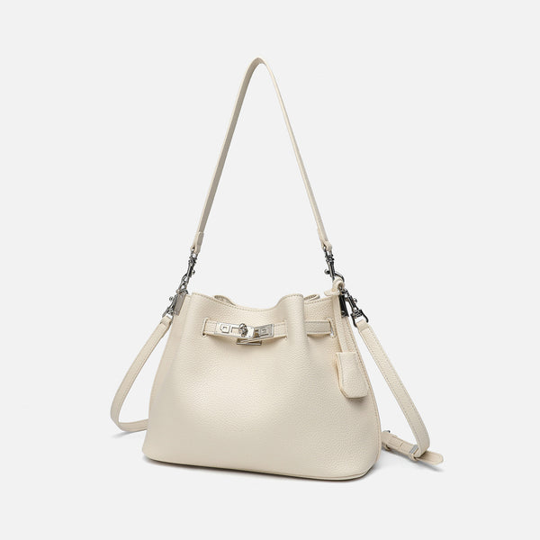 Soft-structured pebbled leather-look bucket bag with silver turn-lock front clasp and adjustable crossbody strap, detail view