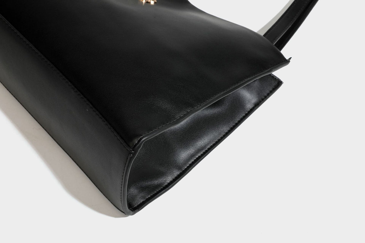 Structured rectangular shoulder tote bag with smooth leather-look finish, long double straps, and gold-tone gourd emblem on