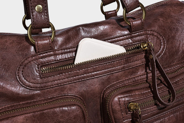 Distressed leather-look vintage satchel shoulder bag with multiple front zip pockets, dual top handles, and brass-tone