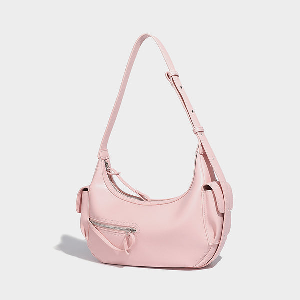Smooth leather-look crescent shoulder bag with front zip pocket, side flap pockets, adjustable strap, and silver-tone, front