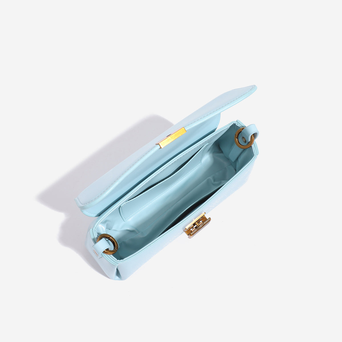 Structured rectangular baguette shoulder bag in pastel sky blue with smooth leather-look finish, ribbed gold-tone turn-lock