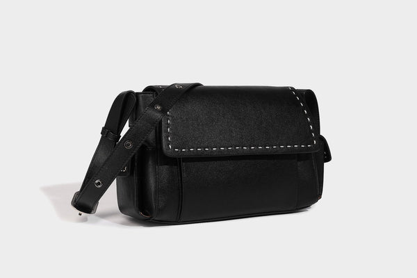 Structured flap crossbody bag in dark brown and cream color-block with white contrast stitching, adjustable shoulder strap