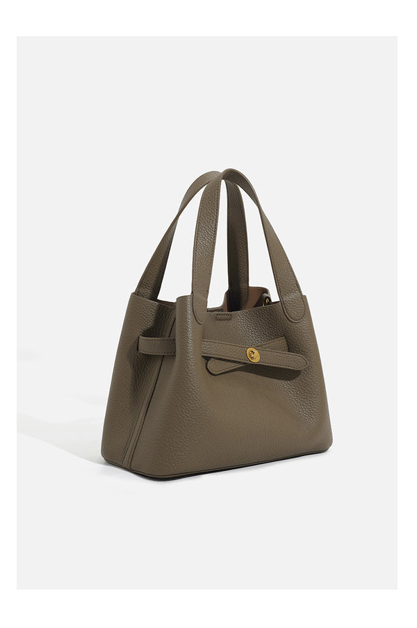 Pebbled trapezoid tote bag with gold turn-lock strap detail and matching snap pouch, detail view 9