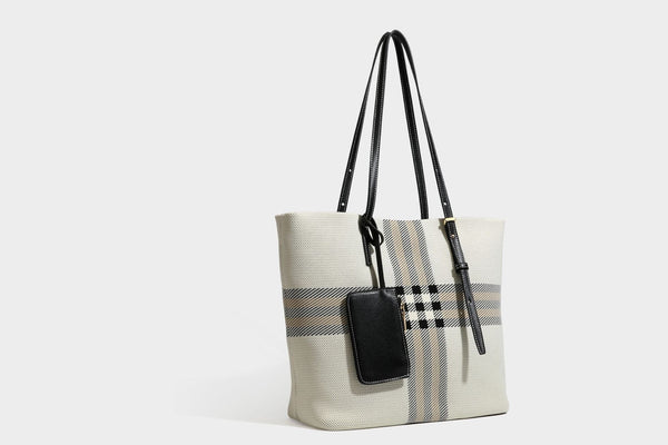 Large structured plaid check tote bag with smooth tan leather-look shoulder straps, attached front zip pouch, and gold-tone