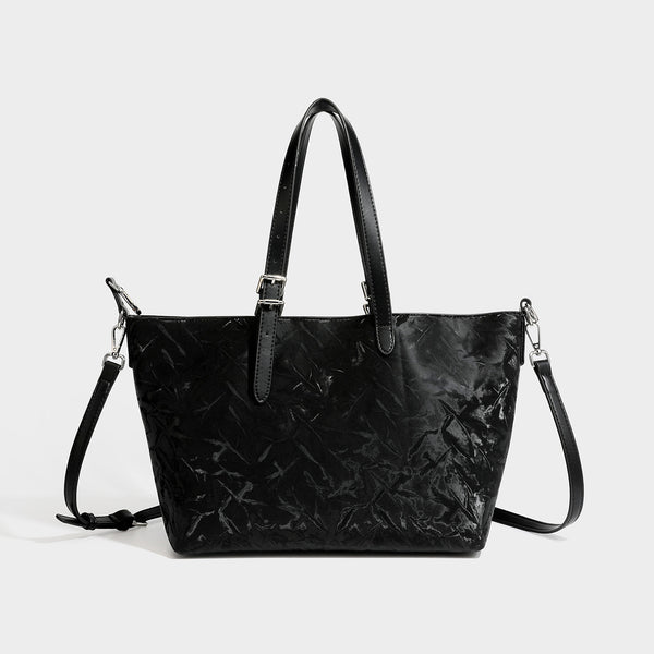 Glossy crinkled metallic-finish tote bag in brown with smooth leather-look top handles, silver-tone hardware, and attached