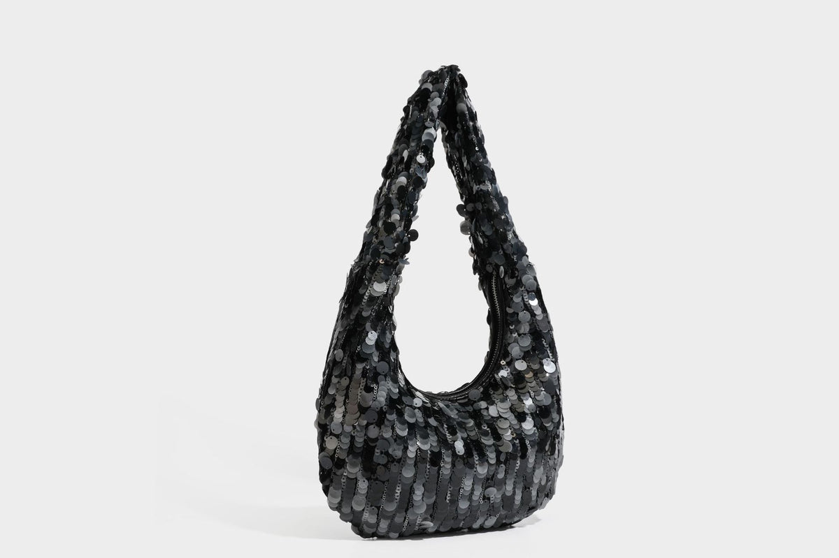 Slouchy crescent hobo shoulder bag covered in overlapping reflective sequin discs with a single integrated strap and top-zip