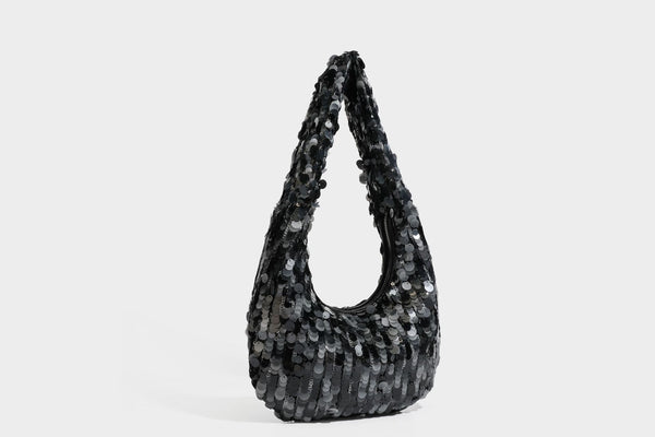 Slouchy crescent hobo shoulder bag covered in overlapping reflective sequin discs with a single integrated strap and top-zip