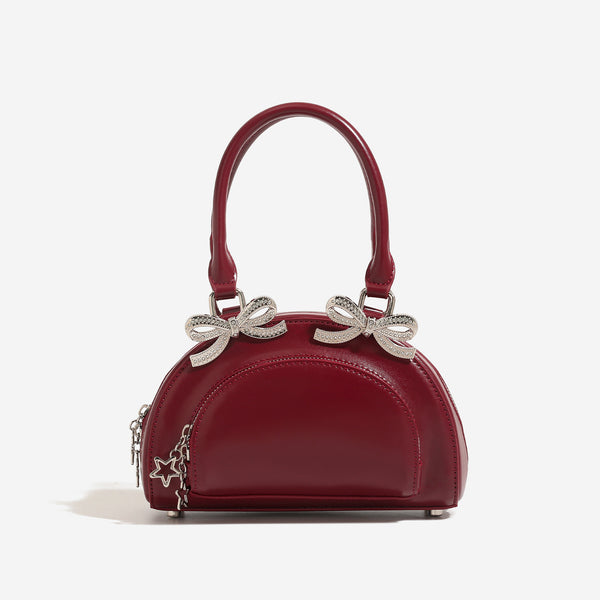 Structured half-moon mini handbag with silver-tone crystal bow hardware and star charm chain, detail view 6