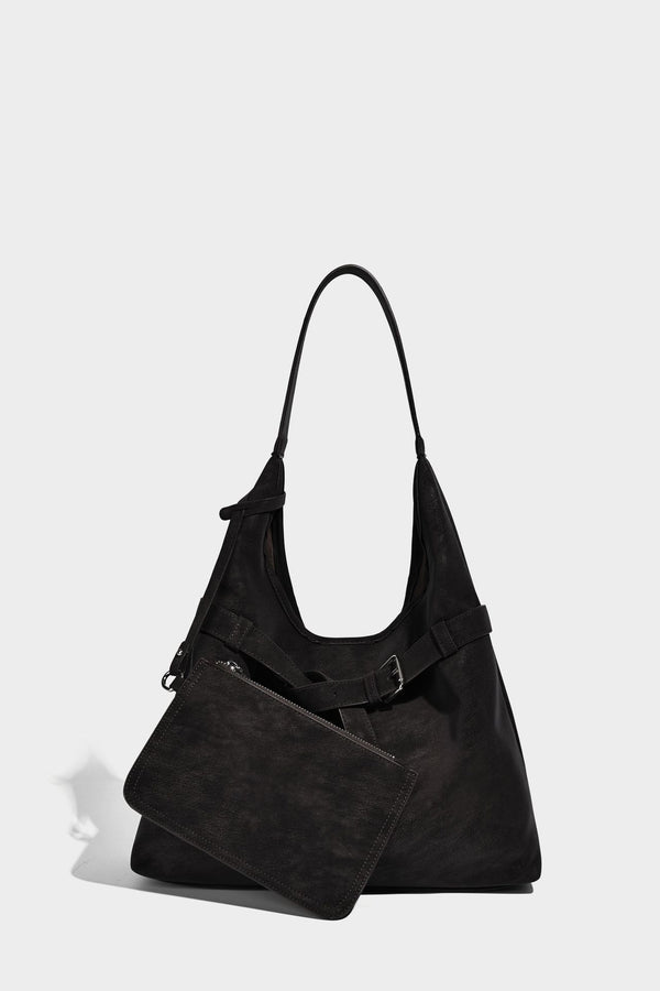 Slouchy oversized shoulder tote bag with matte textured finish, wrap-around buckle strap, and detachable front zip pouch
